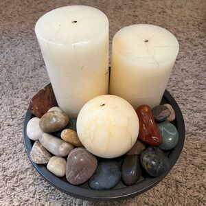 Candles with rocks on pedestal display